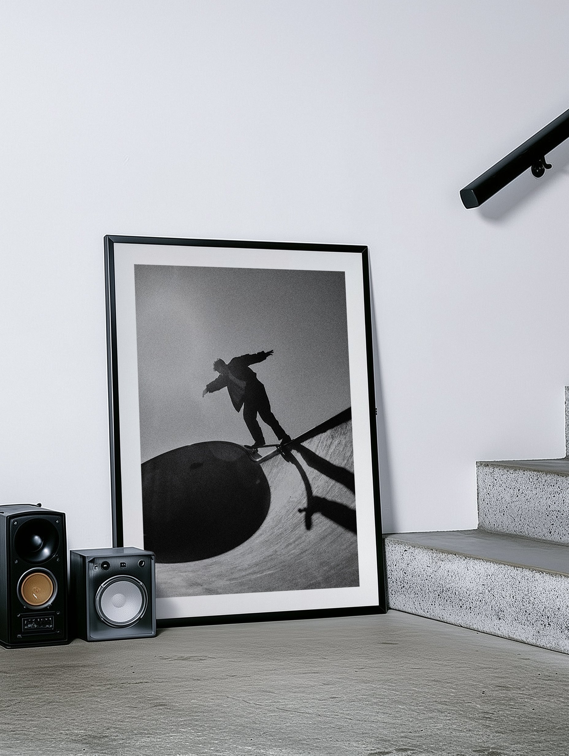 Framed black and white artwork of a person on a skateboard in a modern room.